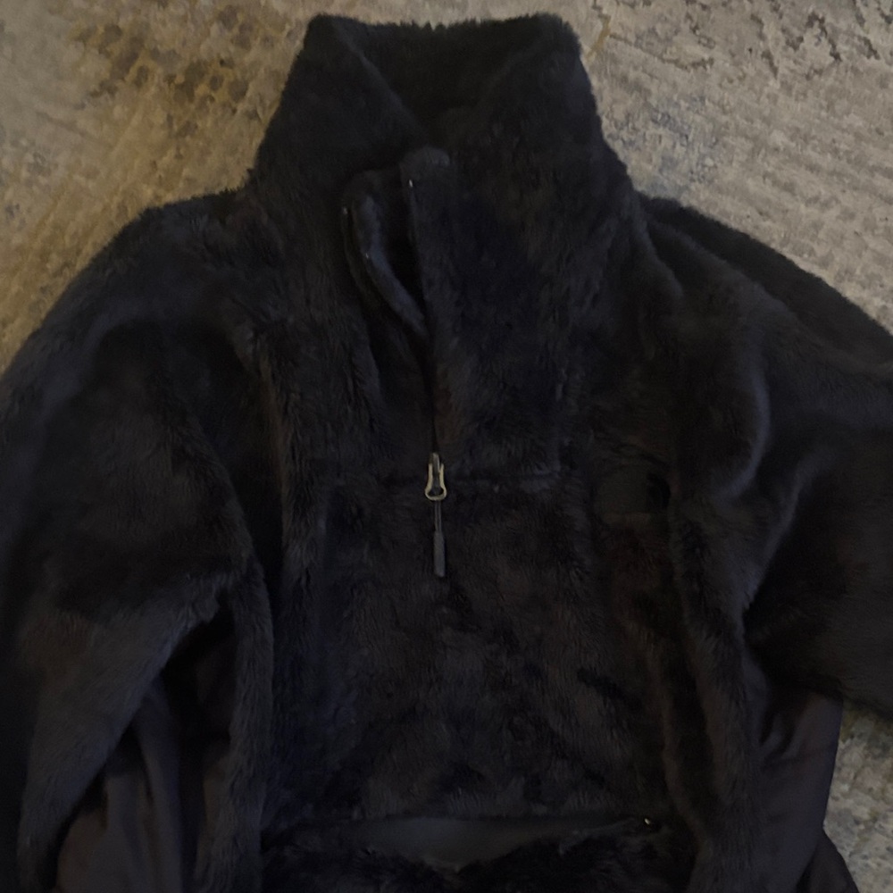 The North Face Black Teddy Jacket.  Front zipper pocket.  Half zip.